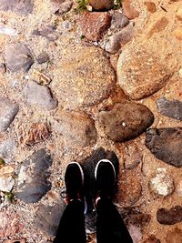 Low section of man standing on rock