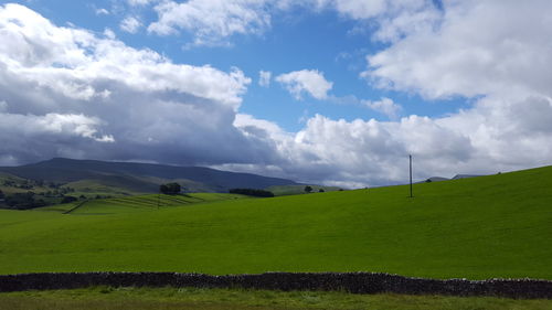 Scenic view of landscape against cloudy sky