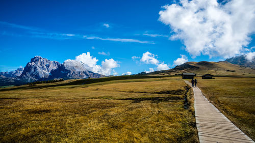 Scenic view of snowcapped mountains against blue sky