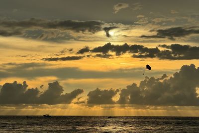 Scenic view of sea against sky during sunset along cenang beach on langkawi, malaysia
