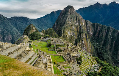 Scenic view of mountains against cloudy sky