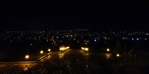 High angle view of illuminated city buildings at night