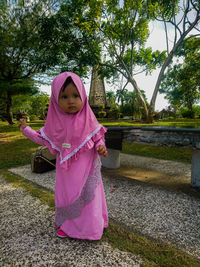 Full length of baby girl wearing modest clothing at park