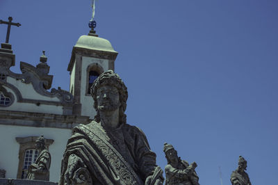 Low angle view of statue against blue sky