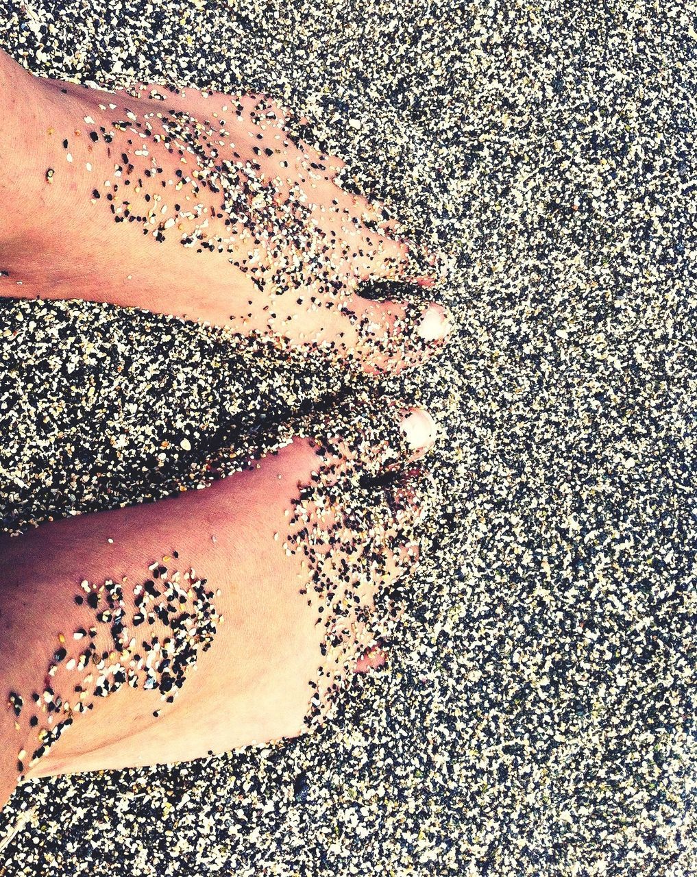 low section, person, high angle view, lifestyles, beach, sand, water, standing, leisure activity, wet, human foot, unrecognizable person, shadow, sunlight, pattern, personal perspective