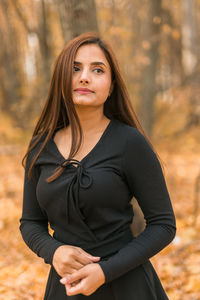 Portrait of young woman standing outdoors