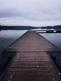 Pier over lake against sky