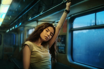 Beautiful woman standing in subway train