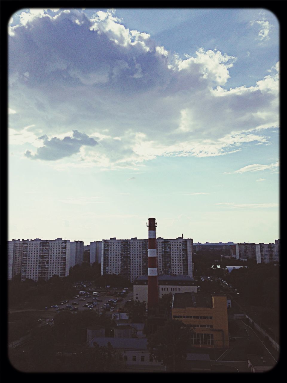 transfer print, building exterior, architecture, auto post production filter, built structure, city, sky, cityscape, cloud - sky, cloud, residential building, city life, residential structure, building, street, residential district, outdoors, transportation, no people, road