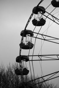 Low angle view of ferris wheel against sky