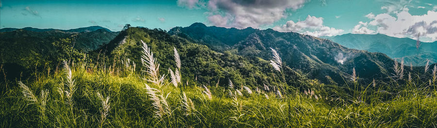 Panoramic view of land and mountains against sky