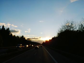 Cars on highway at sunset