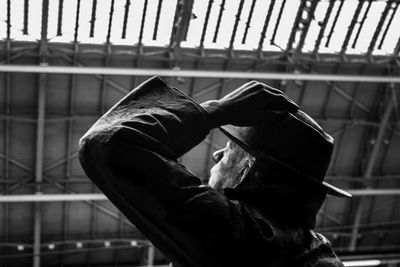 Side view of man holding railing