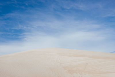 Scenic view of desert against blue sky