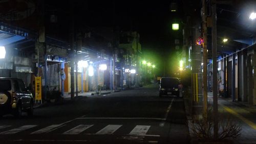 Cars on illuminated city at night