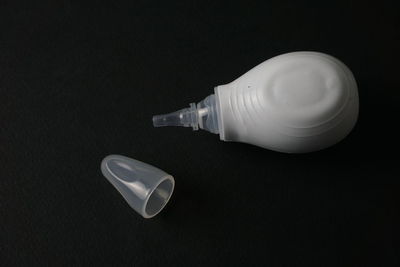 Close-up of electric lamp on table against black background