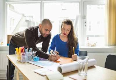 Business people working together at desk in creative office