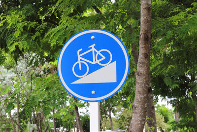 Low angle view of road sign against trees