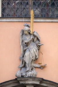 Low angle view of statue against building