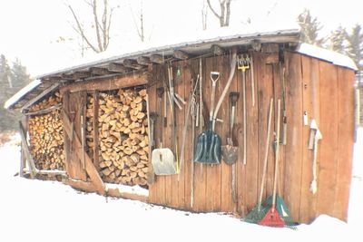 Wooden structure hanging on snow in forest