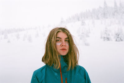 Portrait of beautiful woman standing in snow