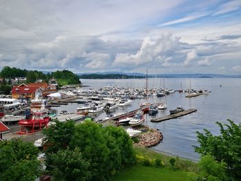 High angle view of boats moored at harbor against sky