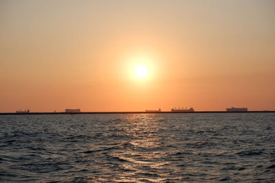 Scenic view of sea against orange sky