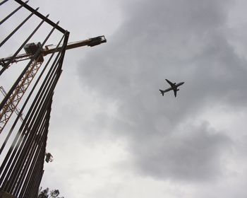 Low angle view of airplane flying against sky