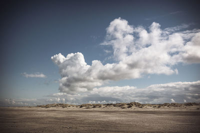 Scenic view of landscape against cloudy sky