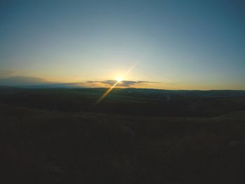 Scenic view of field against sky during sunset