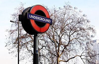 Low angle view of road sign against clear sky