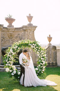 Full length of couple kissing while standing outdoors