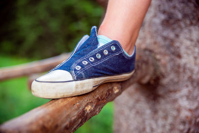 Low section of woman legs on wood