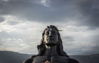 Low angle view of statue against sky