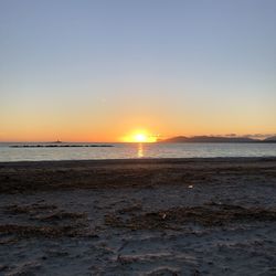 Scenic view of sea against clear sky during sunset