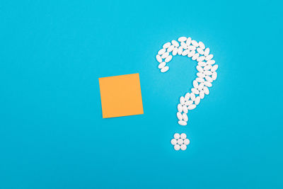 Close-up of arrow symbol on blue background