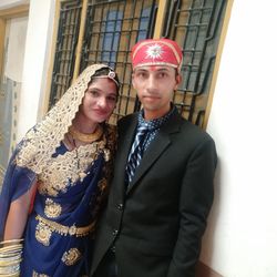 Portrait of young couple standing outdoors