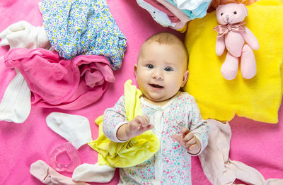 High angle view of cute baby girl playing with stuffed toy