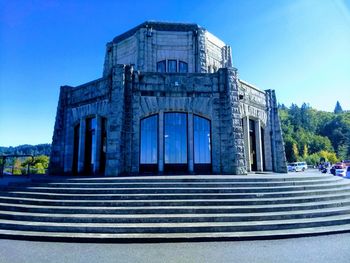 Low angle view of building against clear blue sky