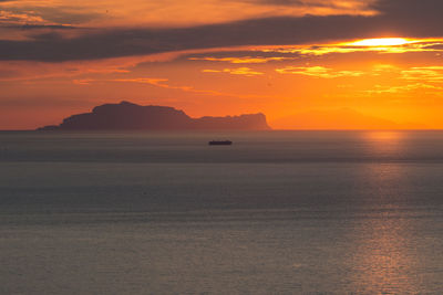 Scenic view of sea against orange sky