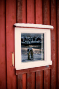 Close-up of reflection of window on door of building