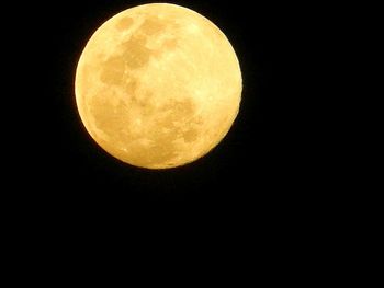 Low angle view of moon against clear sky at night