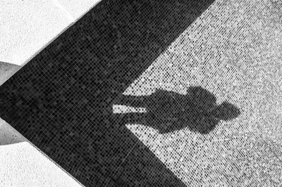 Shadow of person in empty swimming pool