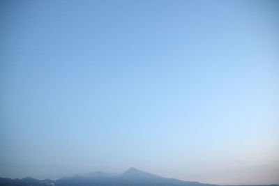 Scenic view of mountains against clear blue sky