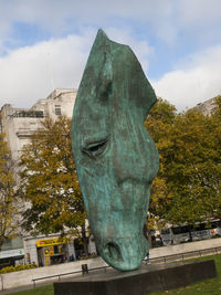 Statue in front of sculpture in park