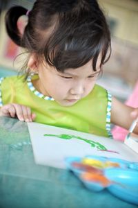Close-up of cute girl holding paper