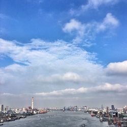 View of cityscape against cloudy sky