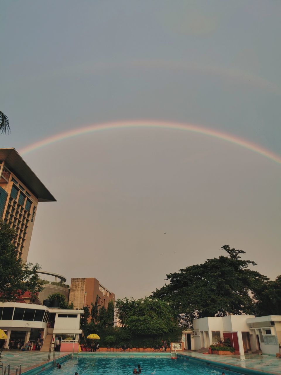 SCENIC VIEW OF RAINBOW OVER BUILDINGS IN CITY