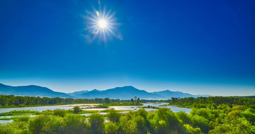 Scenic view of landscape against blue sky