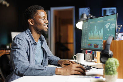 Young man using laptop at office